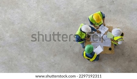 Top view of engineer, architect, contractor and foreman are meeting at the construction building site with floor plan for real estate development project industry and housing timeline usage Royalty-Free Stock Photo #2297192311