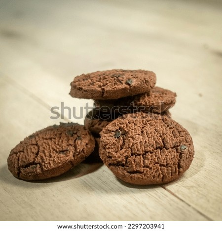 Close up picture of Chocolate chip cookies isolated on wooden background, design for chocolate chip day, national cookie day, world chocolate day.