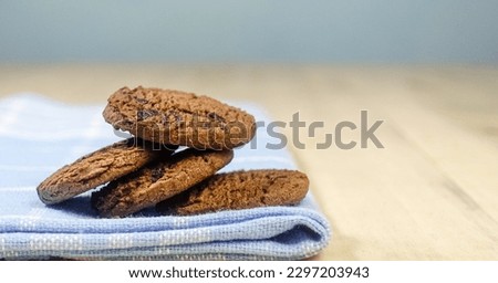 Close up picture of Chocolate chip cookies isolated on wooden background, design for chocolate chip day, national cookie day, world chocolate day.