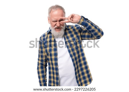 confident mature gray-haired man with a beard in a shirt on a white background with copy space