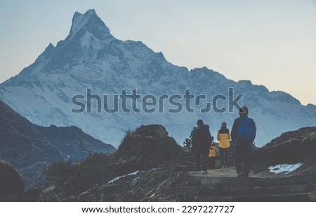 Group of tourist while hiking on Mardi Himal route in Annapurna region of Nepal with beautiful Mt.Machapuchare in the background.