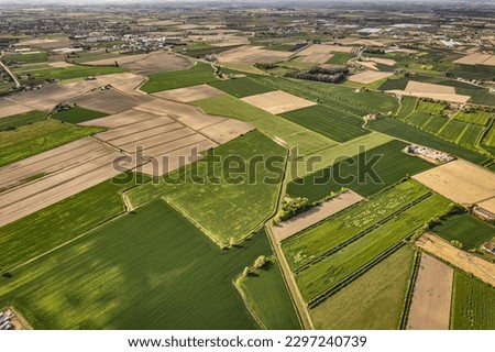Breathtaking aerial view showcasing the vibrant, green landscapes of Italy's fertile Po Valley countryside Royalty-Free Stock Photo #2297240739