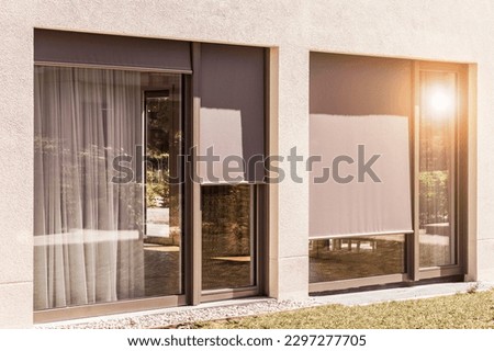 Roller Blinds on Panoramic Window Outside of Modern House. External Shutters. Sun Protection Exterior House. Royalty-Free Stock Photo #2297277705