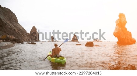 Woman kayak sea. Happy tourist takes sea photo in kayak canoe for memory. Woman traveler poses amidst volcanic mountains during adventurous journey in kayak.