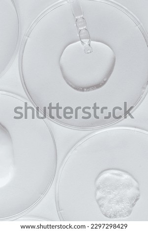 Pipette with Sample of Gels Cosmetic Product in Petri Dish on white background, top view, flat lay Royalty-Free Stock Photo #2297298429