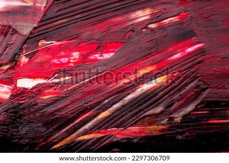 background of large relief strokes of paint in red and burgundy.