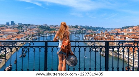 Woman tourist admiring panoramic view of cityscape of Porto- tour tourism in Portugal, Travel in Europa Royalty-Free Stock Photo #2297319435