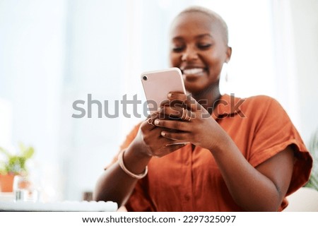Staying engaged is crucial in the modern world. a young businesswoman using a cellphone in an office. Royalty-Free Stock Photo #2297325097