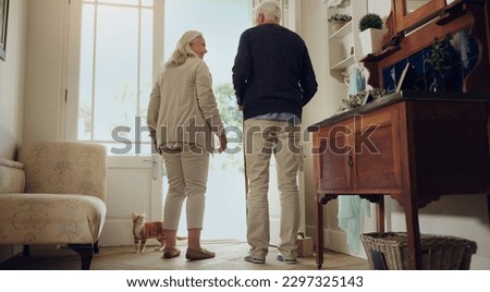 Shall we go for a walk. Full length shot of a happy senior couple standing in their home together during the day.