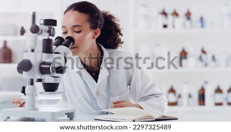 Science is such a fascinating field. a young scientist using a microscope in a lab. Royalty-Free Stock Photo #2297325489