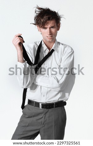 Hes lost his mind. A disheveled young businessman isolated on a white background. Royalty-Free Stock Photo #2297325561