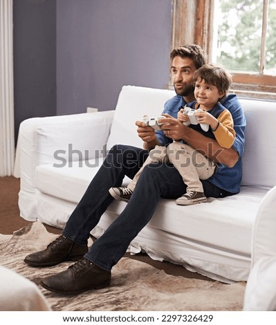 Love, father and son on a couch, video game and bonding at home, happiness and relax together. Family, dad and boy with parent, kid and male child playing online, smile and loving with cyber gamer