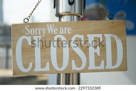 Closed English letter sign hung on the entrance door of the store                              
