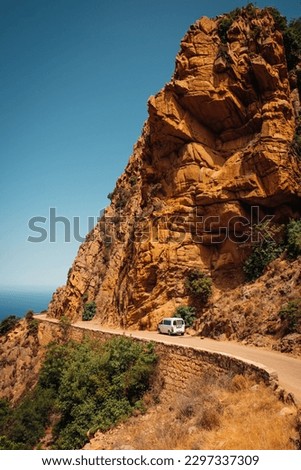 PIANA, FR - Jun 25, 2022: A car on the road in Calanques de Piana in Corsica, France Royalty-Free Stock Photo #2297337309