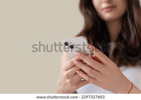 Young woman hands using smartphone close up. Teenage girl scrolling, watching video reels, chatting, messaging social media, online shopping. Technology in daily life