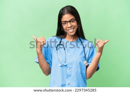Young African american nurse woman over isolated background with thumbs up gesture and smiling