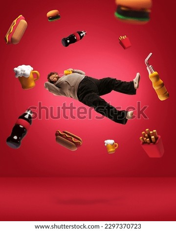 Food addiction. Contemporary art collage with adult overweight man dreaming about junk food, beer, cola, french potato, sandwich, hot dog over red background. Concept of food, bad habits, adiposity Royalty-Free Stock Photo #2297370723
