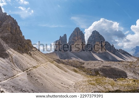 Dobbiaco, Italy-September 11, 2021:people on the path at the base of the famous three peaks of Lavaredo during a sunny day