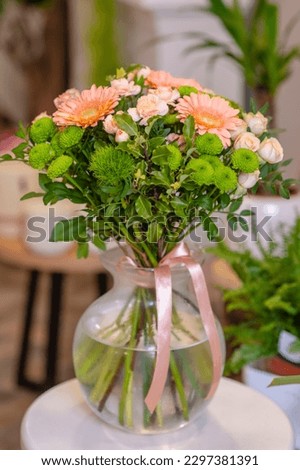 Bouquet with gerberas and other flowers in a vase