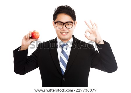 Healthy Asian businessman OK with red apple  isolated on white background