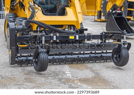 Skid Steer Attachment With Hydraulic Angle Power Box Rakes Construction Machine Royalty-Free Stock Photo #2297393689