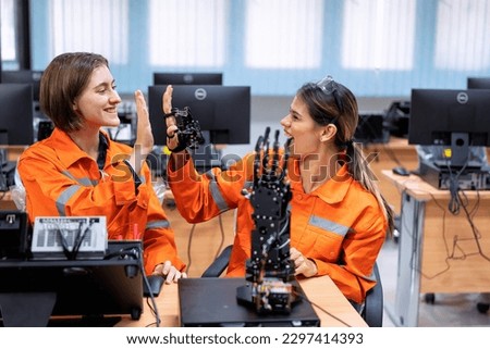Girl engineer in robot industry fabrication research room simulate testing robot arm on operation