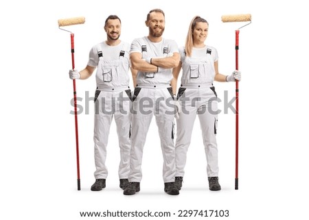 Male and female house painters in white overall pants smiling at camera isolated on white background Royalty-Free Stock Photo #2297417103