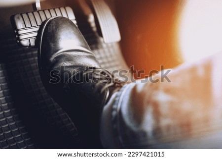 man stepping on car brake To slow down, stop the car both normal and abruptly, transfer the weight to press the front wheels to grip the road and turn more stable Royalty-Free Stock Photo #2297421015