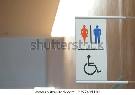  Signs on the wall guiding the location of indoor restrooms                              