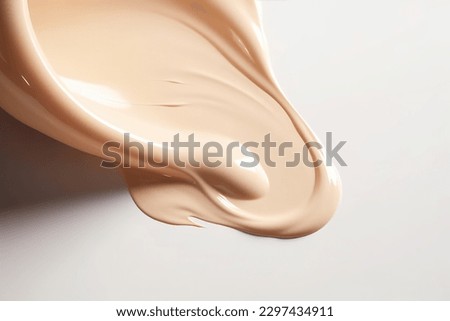 Liquid foundation strokes on light color background, Makeup creamy texture, Skin tone cosmetic product smear smudge swatch Royalty-Free Stock Photo #2297434911