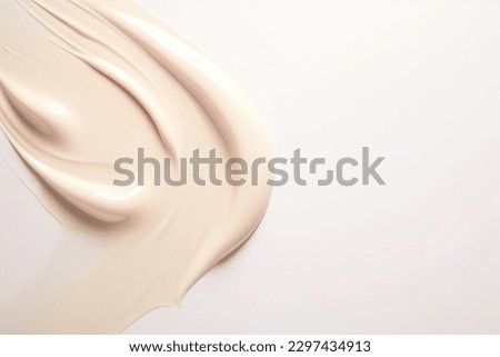 Liquid foundation strokes on light color background, Makeup creamy texture, Skin tone cosmetic product smear smudge swatch Royalty-Free Stock Photo #2297434913
