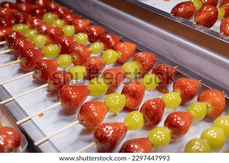 Korean Fruit Candy Stick with Strawberry and Grape Coated with Sugar Royalty-Free Stock Photo #2297447993