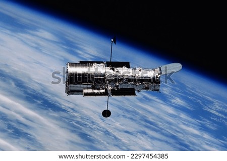 A space telescope in outer space. Elements of this image furnished NASA. High quality photo Royalty-Free Stock Photo #2297454385