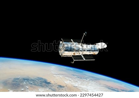 A space telescope in outer space. Elements of this image furnished NASA. High quality photo Royalty-Free Stock Photo #2297454427