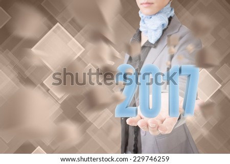 Concept of 2017, business woman holding a 3d text.