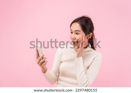 Asian beautiful woman exited surprise face expression . female feels shocked. exciting smile and happy adorable rejoices. Very enjoy and fun relax time. wow, girl holding smartphone. Smile.
 Royalty-Free Stock Photo #2297480155
