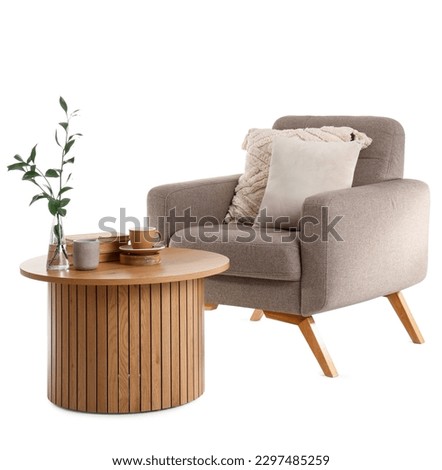 Cozy armchair and coffee table isolated on white background Royalty-Free Stock Photo #2297485259