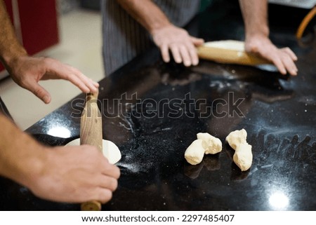 Traditional way of preparing indian food, making roti bread. Picture of traditional India cuisine made of fresh ingredients taken during cooking class in Goa.