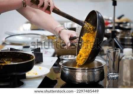 Traditional way of preparing indian food mushroom curry using gas pan. Picture of traditional India cuisine made of fresh ingredients taken during cooking class in Goa