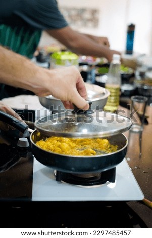 Traditional way of preparing indian food mushroom curry using gas pan. Picture of traditional India cuisine made of fresh ingredients taken during cooking class in Goa