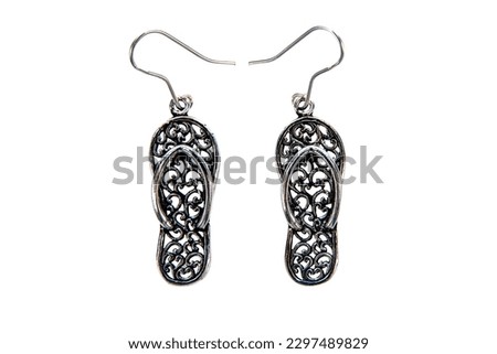 Silver sandals earrings isolated on white background.