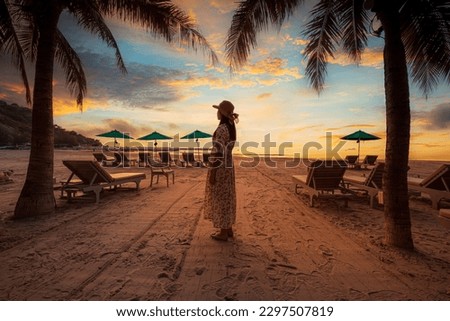 woman and beach in the morning,Summer travel vacation concept, Traveler asian woman with hat relax and sightseeing on Kata beach at sunset in Phuket, Thailand