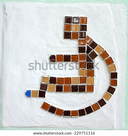 wheelchair sign on cement wall 