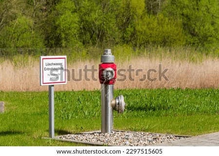 Fire protection hydrant on an industrial site with a sign for fire-fighting water extraction point Use only when necessary