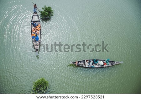 Aerial view of old fisherman boats in the river Krishna, Andhra Pradesh state India. High angle, beautiful sea, and tourists boats Royalty-Free Stock Photo #2297523521
