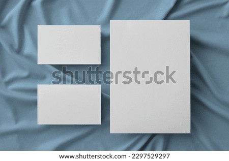 Stationary With Big Card And Two Bussiness Cards Over Fabric Background