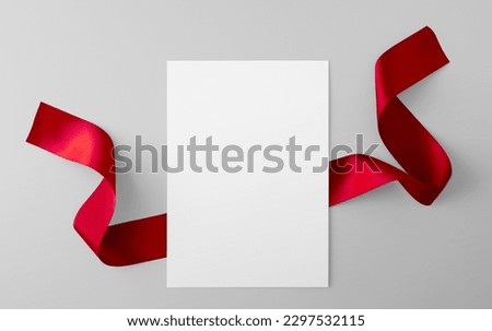 Paper Sheet with Red Ribbon
