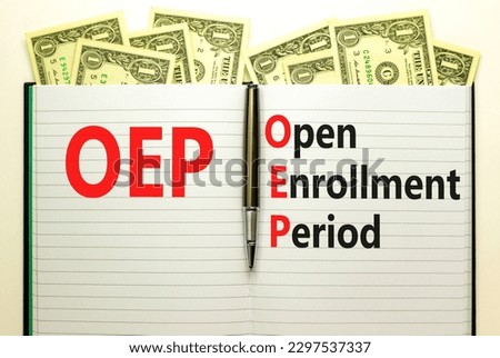 OEP symbol. Concept words OEP Open enrollment period on beautiful white note. Dollar bills. Beautiful white table white background. Medical and OEP Open enrollment period concept. Copy space.