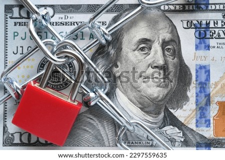 Lock and chain on cash, money restrictions, frozen assets, business finances concept Royalty-Free Stock Photo #2297559635