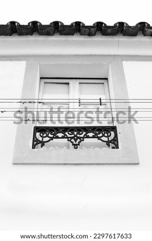 Typical Portuguese window with hanging clothes. Monochrome picture